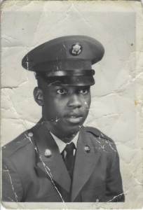 an old black and white photo of Angela's father wearing an army suit and cap.