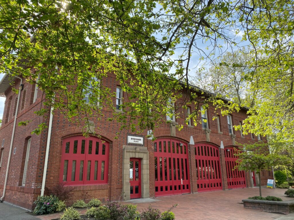 the home of Byrd Barr Place in 2020, a brick firehouse with four firehouse doors painted in red