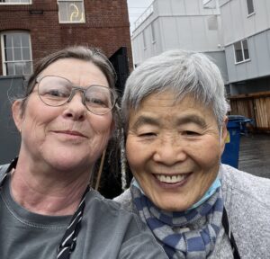 Christa and another volunteer take a break from loading groceries.