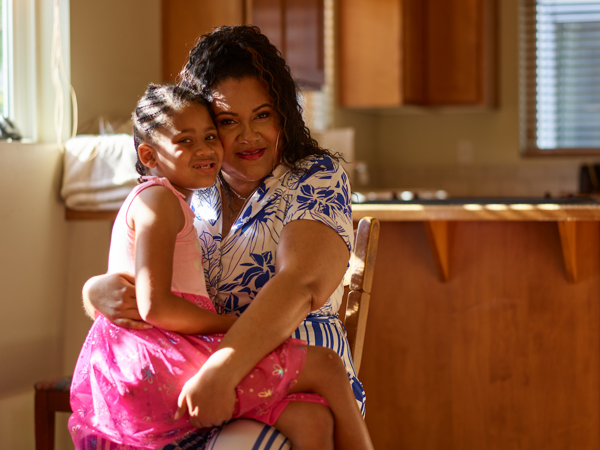 Marissa Garret and her child A woman sitting in a chair while holding her young child on her lap