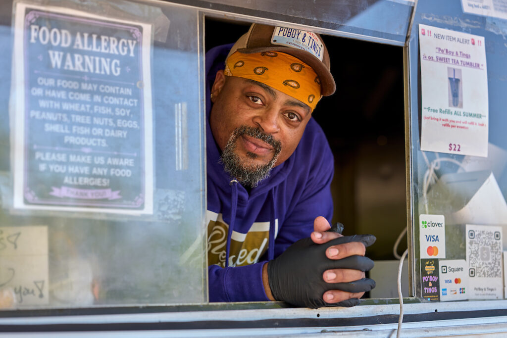 Man leaning out of a food truck window